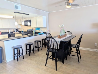 Dining room with wood ceiling, baseboards, visible