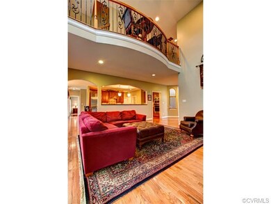 A versatile Loft with hardwood floor overlooks the