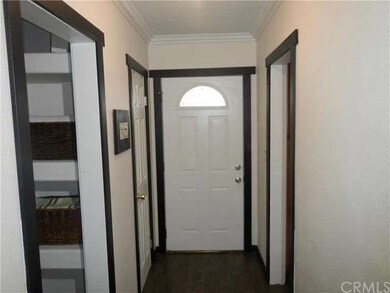 Front door and hallway with crown molding.