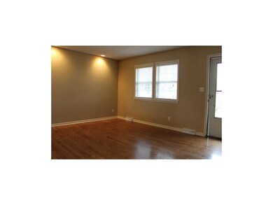 Living room with beautifully refinished hardwood f