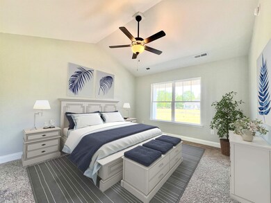 Carpeted bedroom with lofted ceiling and ceiling f
