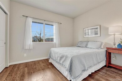 Main-Level Front Bedroom with hardwood floors and front yard view.