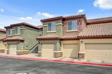 Mediterranean / spanish house with stone siding, stucco siding, a tiled roof, and an attached garage