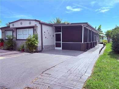 View of front of property with a sunroom and driveway