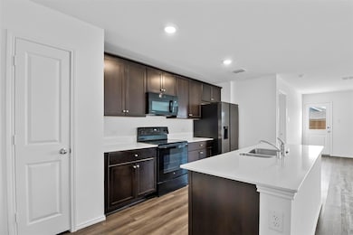 Kitchen with light wood-type flooring, visible ven