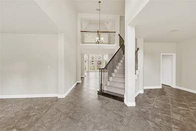 Inside, the foyer opens dramatically, where a grac
