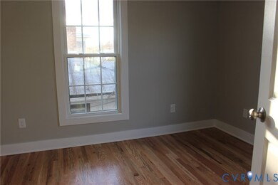 Empty room featuring wood finished floors and baseboards
