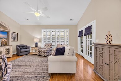 Living room featuring vaulted ceiling, wood finish