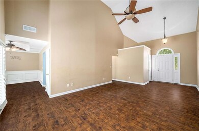 Foyer featuring high vaulted ceiling, a ceiling fan, wood finished floors, and baseboards