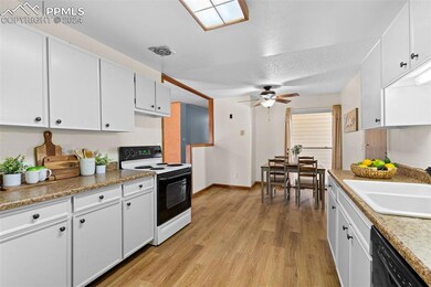 Kitchen featuring white cabinets, light hardwood /