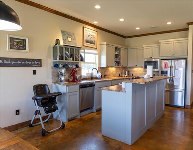 Kitchen featuring crown molding, tasteful backspla