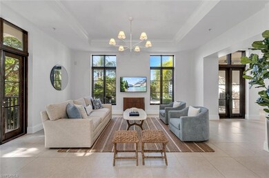 Tiled living room with french doors, crown molding