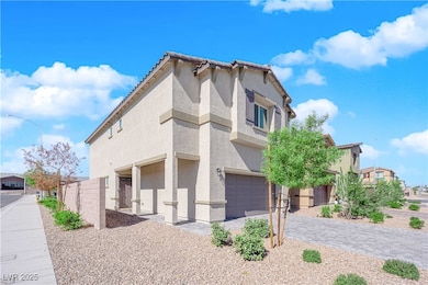 View of side of property featuring a garage and st