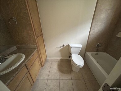 Bathroom with tile patterned floors, vanity, and washtub / shower combination