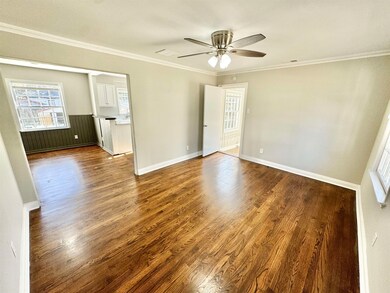 Living Room with hard wood floors, crown molding, 