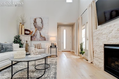 Living room with a fireplace, a towering ceiling, 