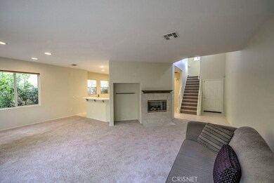 New carpet and paint throughout the house done AFTER owner moved out.

Living room opens up into the kitchen.
