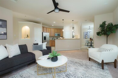 Living area with a ceiling fan, recessed lighting