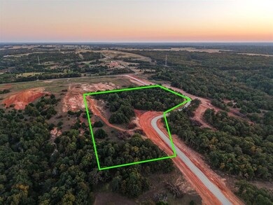 View of property location featuring property parcel outlined and a heavily wooded area