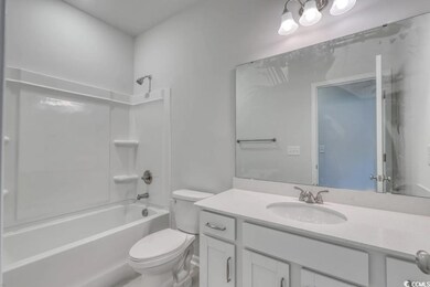Full bathroom featuring vanity, toilet, and shower