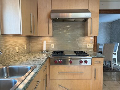 Wolf cooktop and vented hood in kitchen