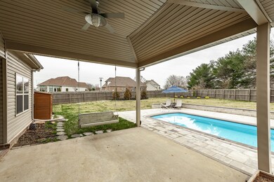 A Covered Patio w/Fan/Light off Covered Porch Area.  Notice the Spacious Back Yard.