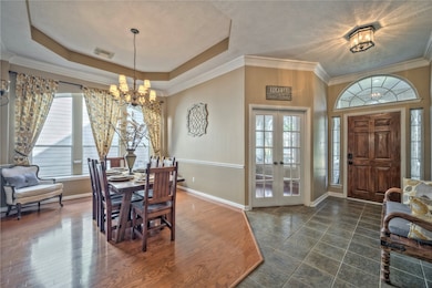 Love the dining room with tray ceiling and wood floors.