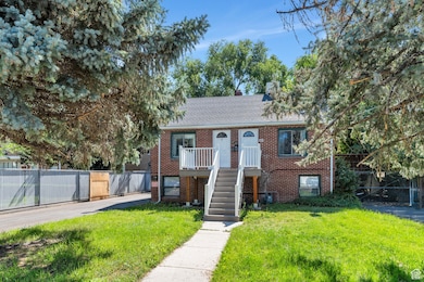 View of front of house with roof with shingles and brick siding