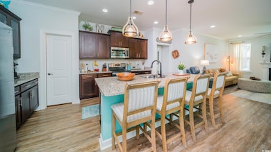 Kitchen featuring open floor plan, light wood-type