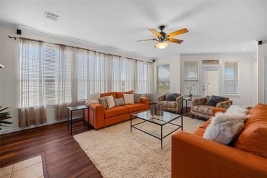 Living room featuring ceiling fan, dark wood-type 
