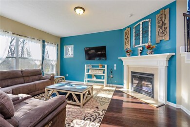 Large family room with gas fireplace and durable hardwood floors. 
