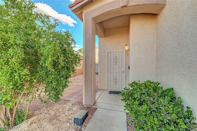 Property entrance with stucco siding and a patio a