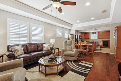 Living room with wood-type flooring, ceiling fan, 