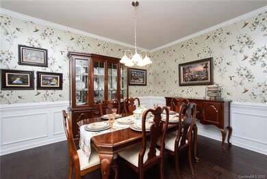 The formal dining room offers mouldings, hardwood 