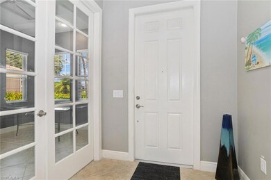 Doorway to outside featuring baseboards, french doors, and tile patterned flooring