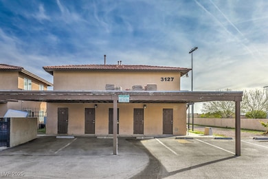 View of building exterior featuring covered parkin