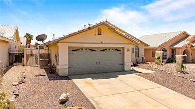 View of front of home with a gate, stucco siding,
