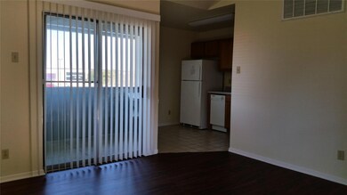Spare room featuring wood finished floors and bas