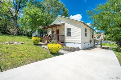 Bungalow featuring crawl space, driveway, a front lawn, and covered porch