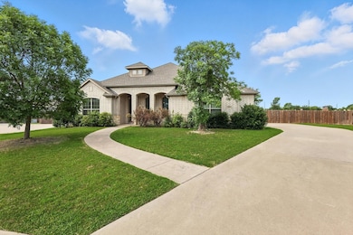 French country style house featuring brick siding and a shingled roof