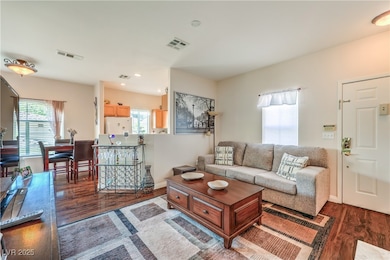 Living area with wood finished floors, recessed li