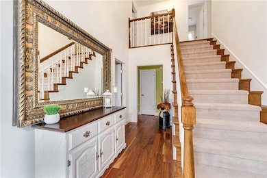 Gleaming wide-plank hardwoods and extra wide stair