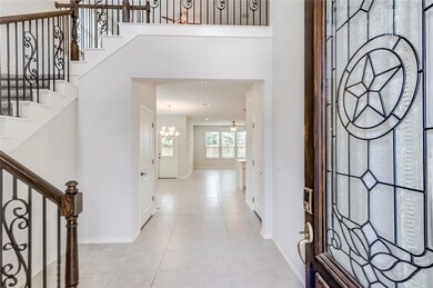 Foyer entrance featuring a chandelier, baseboards