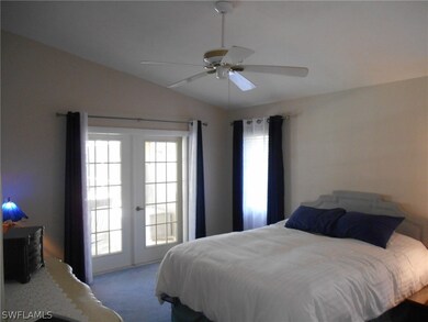 Master bedroom with vaulted ceiling and French doors to the lanai.