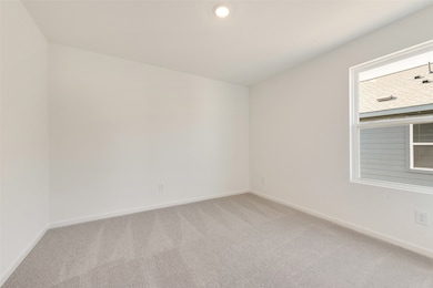 Empty room with carpet flooring and recessed lighting