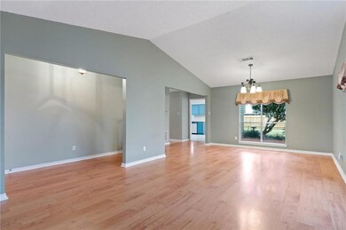 View of living room toward back of home. This home