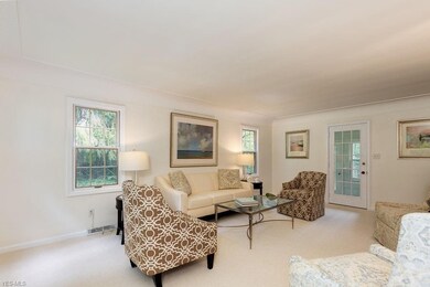 Light filled living room with access to sun room /