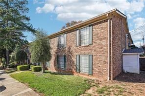 View of front of home featuring brick siding and a front yard