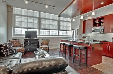 The large bank of windows spans the kitchen and li