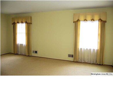 The spacious living room has a fresh neutral color